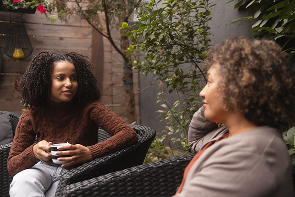 two women chatting on a patio